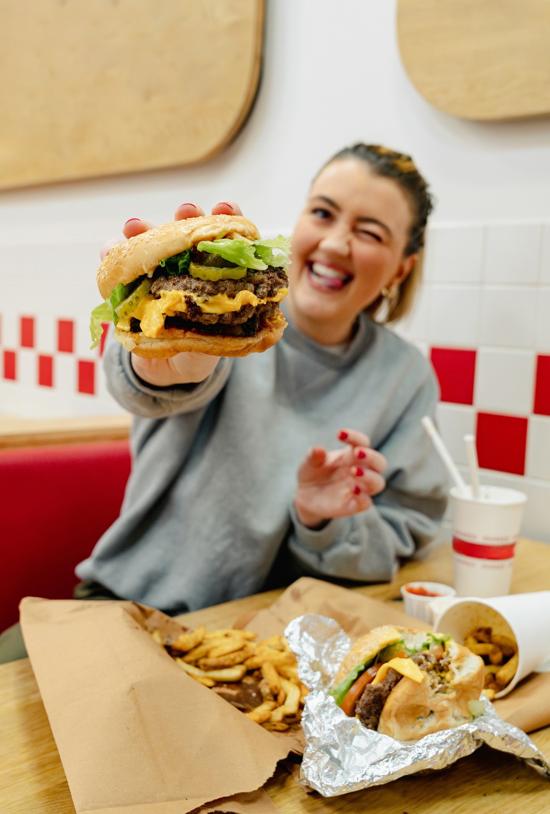 Guest holding up a burger